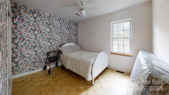 bedroom featuring ceiling fan and light parquet flooring