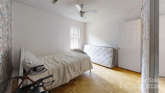 bedroom featuring ceiling fan and light parquet floors