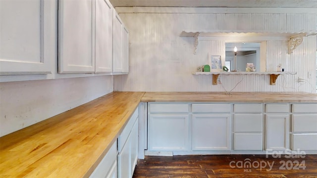 kitchen with white cabinetry and wood counters