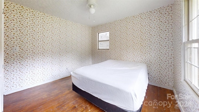 bedroom featuring ceiling fan and dark wood-type flooring