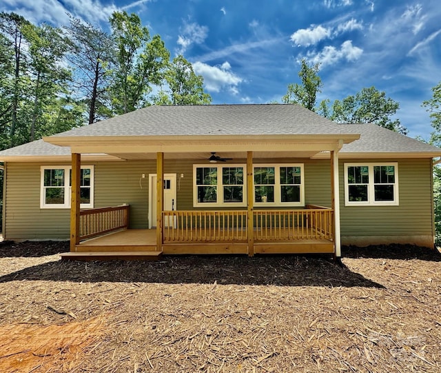 back of property with ceiling fan