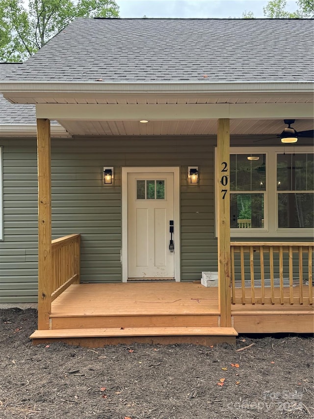 view of exterior entry featuring covered porch