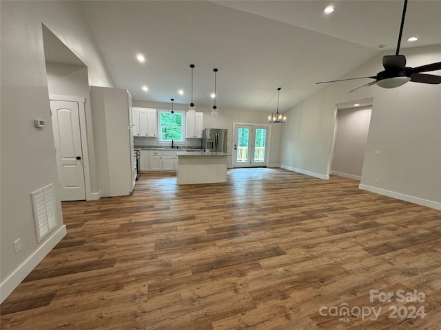 kitchen with white cabinetry, a center island, stainless steel fridge with ice dispenser, decorative light fixtures, and ceiling fan with notable chandelier