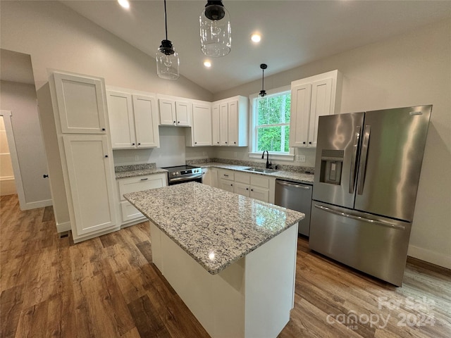 kitchen featuring white cabinetry, a kitchen island, stainless steel appliances, and decorative light fixtures