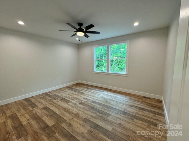 empty room featuring ceiling fan and hardwood / wood-style flooring