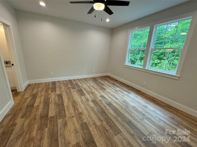 empty room with ceiling fan and wood-type flooring