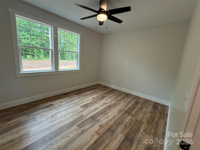 spare room featuring ceiling fan and hardwood / wood-style flooring