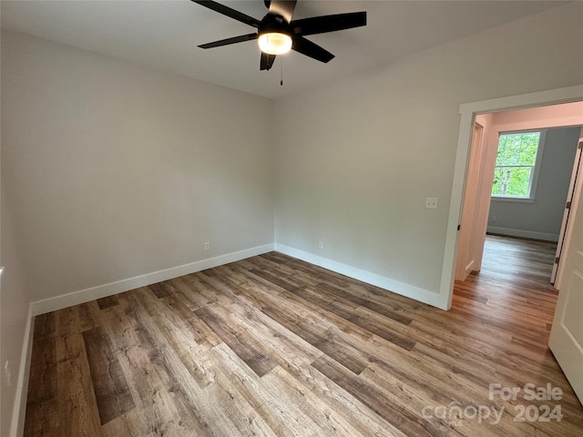 empty room featuring hardwood / wood-style flooring and ceiling fan