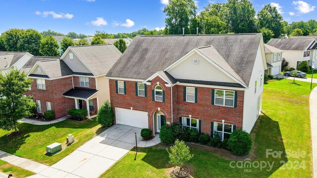 multi unit property with a front yard and a garage