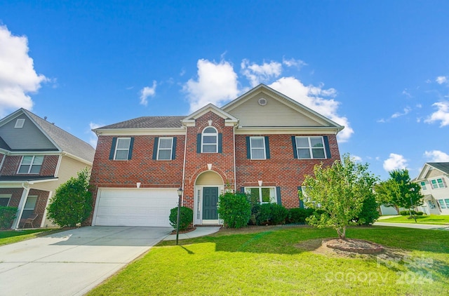 view of front of property with a garage and a front lawn