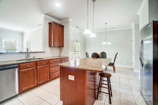 kitchen featuring appliances with stainless steel finishes, a kitchen island, light stone countertops, a kitchen bar, and french doors