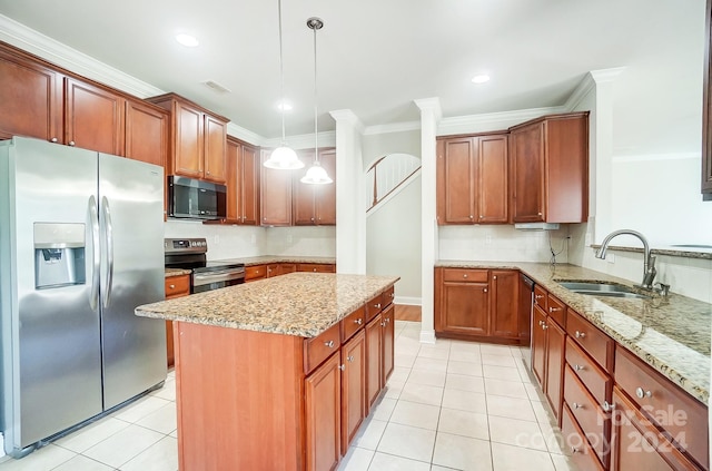 kitchen featuring pendant lighting, sink, light stone counters, and appliances with stainless steel finishes