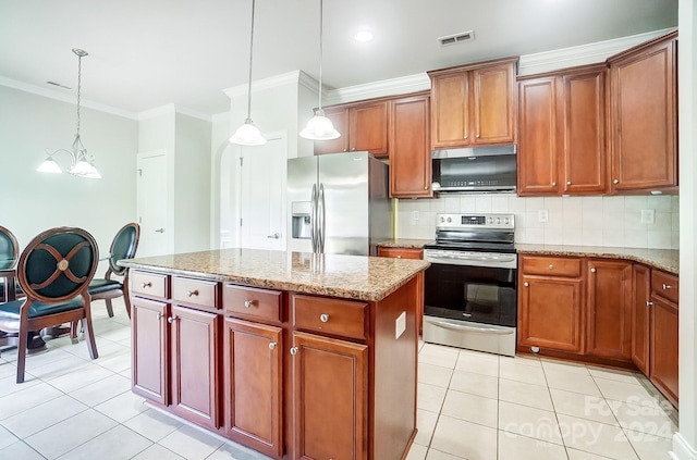 kitchen with light stone counters, decorative light fixtures, a center island, stainless steel appliances, and backsplash