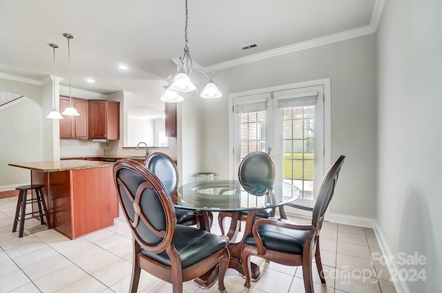 dining room featuring ornamental molding, sink, light tile patterned floors, and french doors