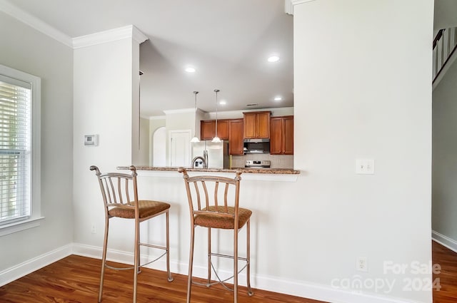 kitchen with a healthy amount of sunlight, stainless steel appliances, kitchen peninsula, and decorative backsplash