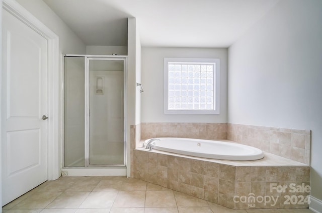 bathroom with tile patterned floors and separate shower and tub