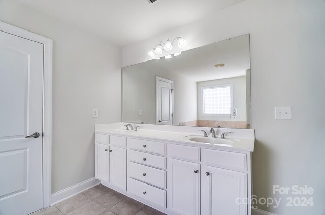 bathroom featuring tile patterned flooring and vanity