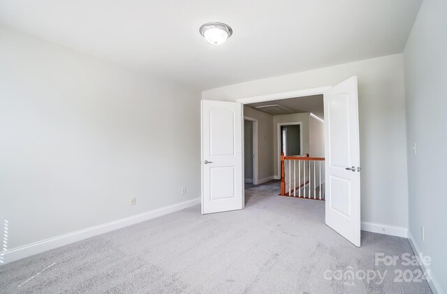 unfurnished bedroom with light colored carpet