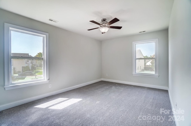 empty room with ceiling fan and carpet flooring