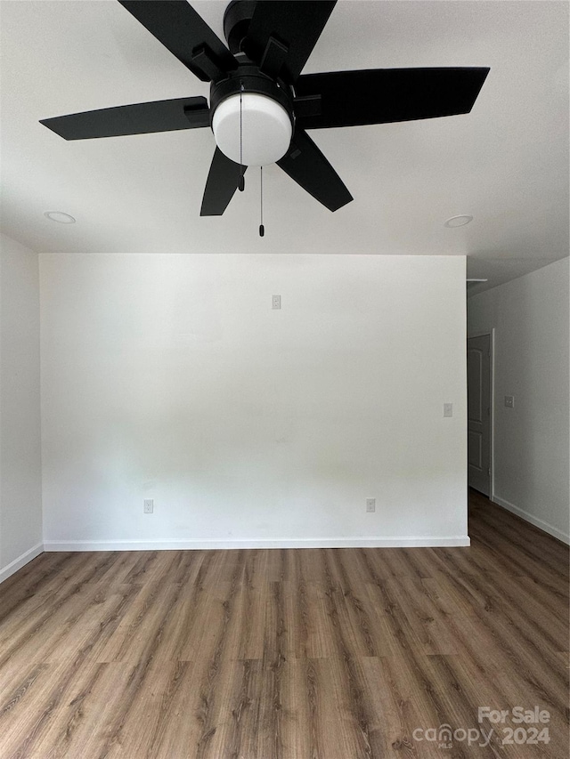 unfurnished room with ceiling fan and hardwood / wood-style floors