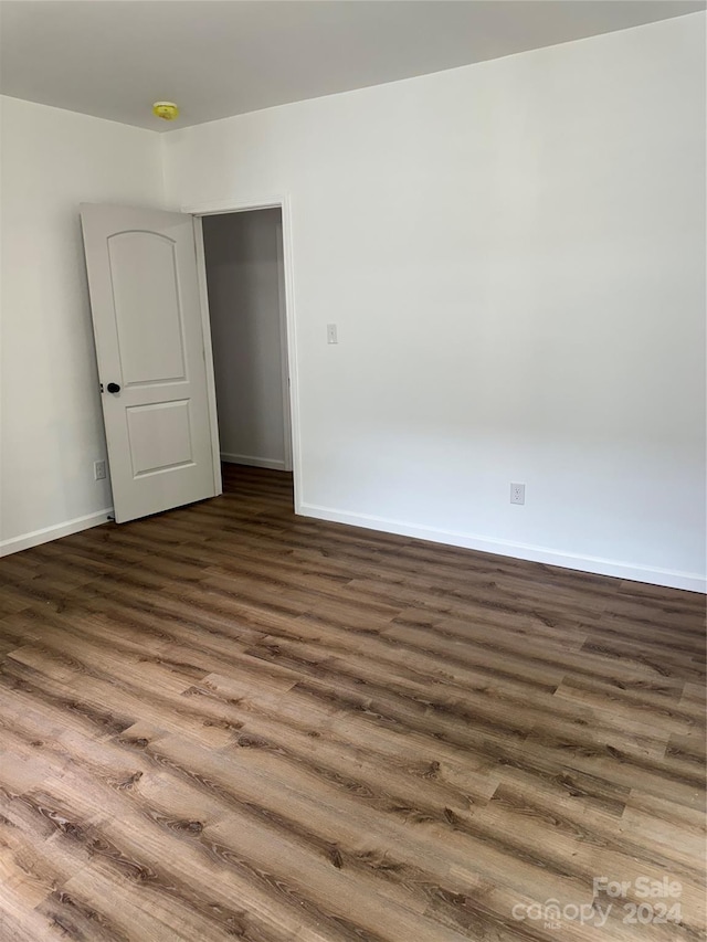 empty room with dark wood-type flooring