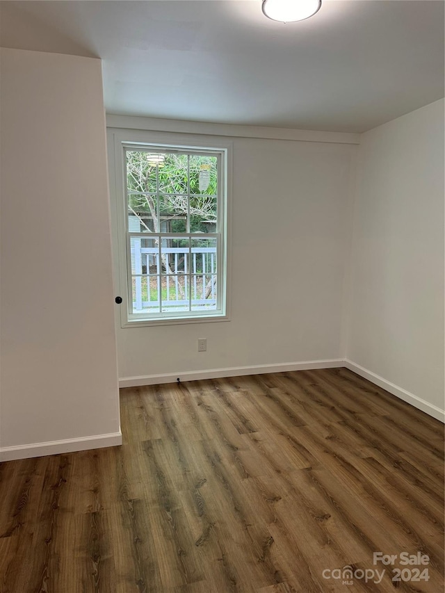 empty room featuring dark wood-type flooring