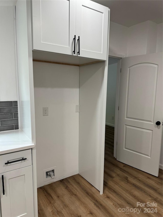 laundry room with hardwood / wood-style floors and washer hookup