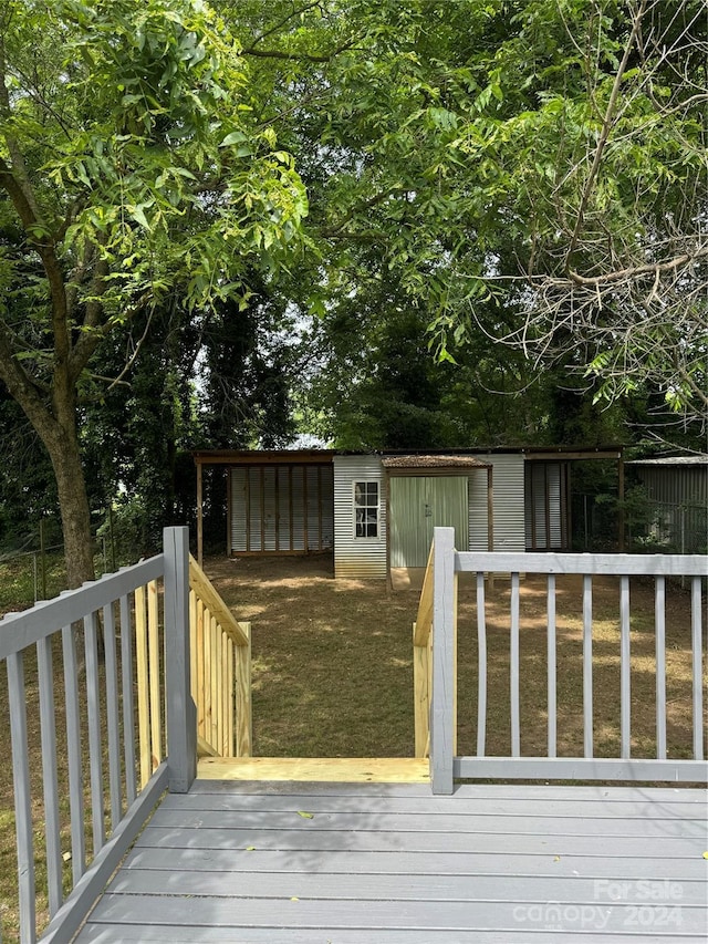 wooden terrace featuring an outdoor structure