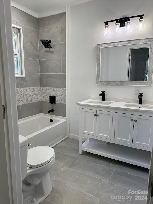 full bathroom with vanity, toilet, and tiled shower / bath