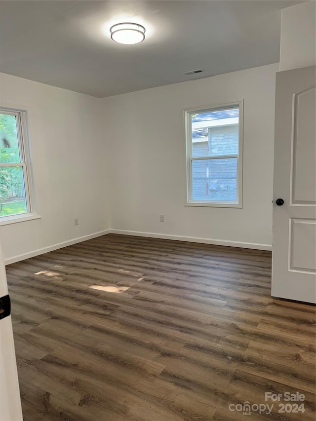 unfurnished room featuring dark hardwood / wood-style floors