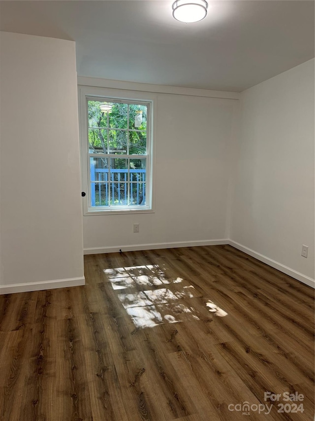 spare room with dark hardwood / wood-style flooring