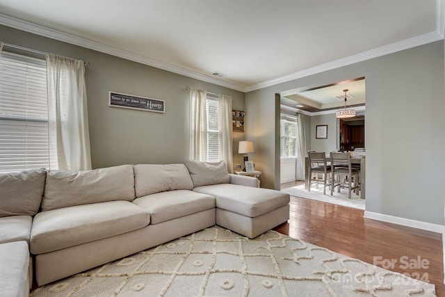 living room with hardwood / wood-style floors and crown molding