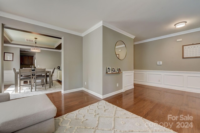 interior space with hardwood / wood-style flooring and ornamental molding