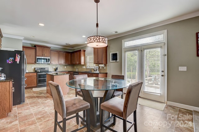 tiled dining space with ornamental molding and sink