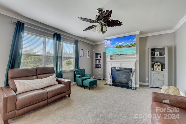 carpeted living room featuring a high end fireplace, ceiling fan, and ornamental molding