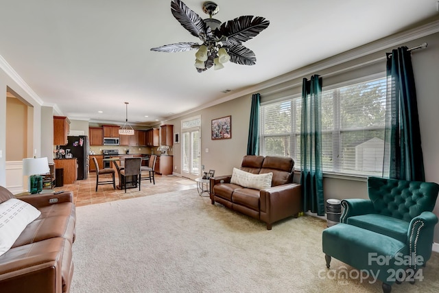 carpeted living room with ceiling fan and crown molding