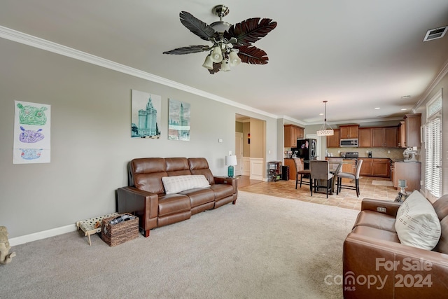 carpeted living room with ceiling fan and crown molding