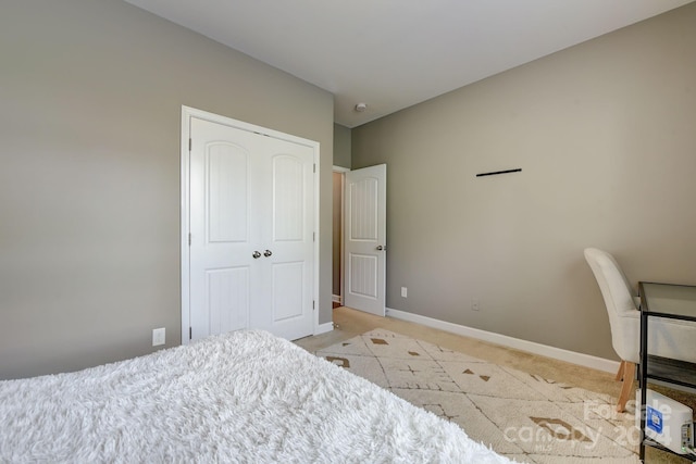 bedroom with a closet and light colored carpet