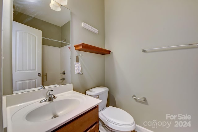 bathroom with vanity, toilet, and walk in shower