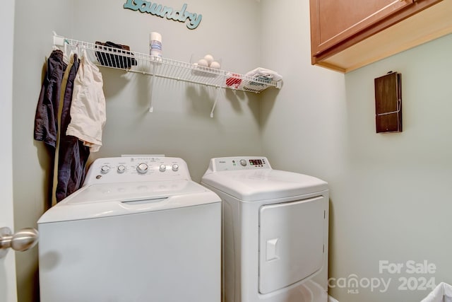 washroom featuring cabinets and independent washer and dryer