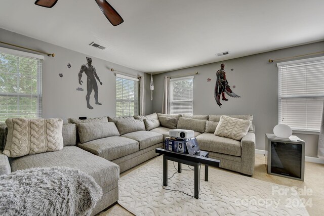 living room featuring light carpet and ceiling fan