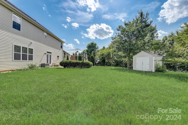 view of yard with a storage unit and cooling unit