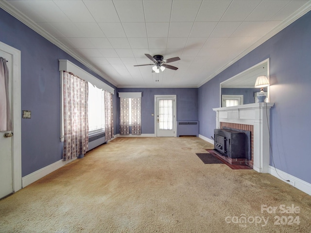 unfurnished living room with radiator, ceiling fan, carpet flooring, and ornamental molding