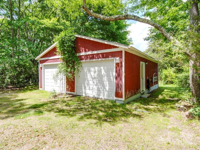 view of outbuilding featuring a yard and a garage