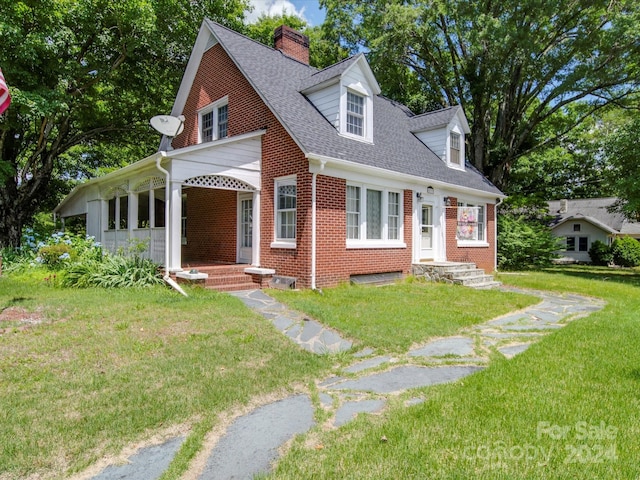 new england style home with a front lawn