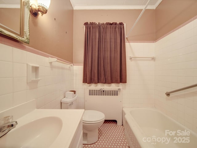 full bathroom featuring toilet, crown molding, tile walls, vanity, and radiator