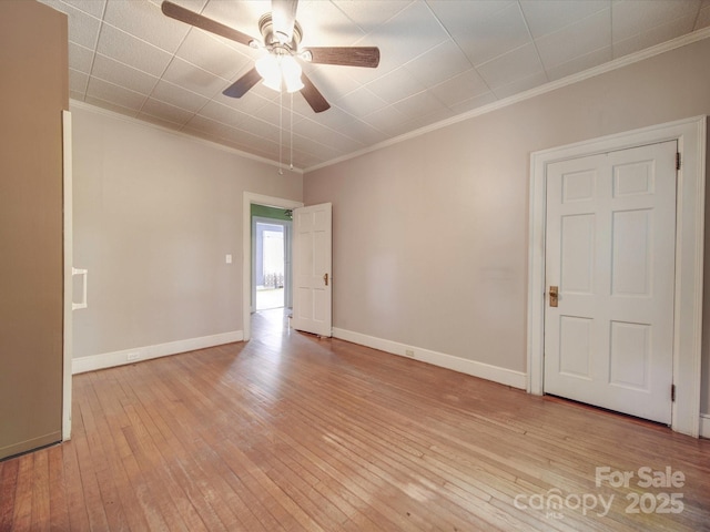 unfurnished room with crown molding, light hardwood / wood-style flooring, and ceiling fan