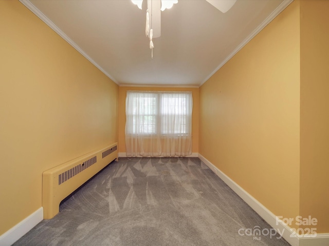 carpeted spare room with radiator and crown molding