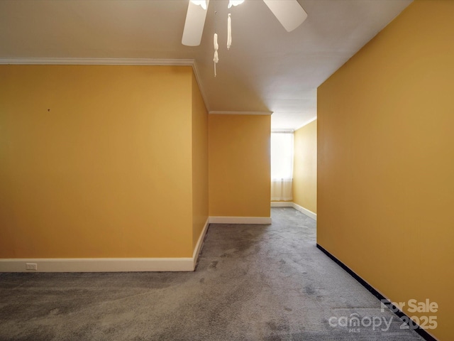 carpeted spare room with ornamental molding and ceiling fan