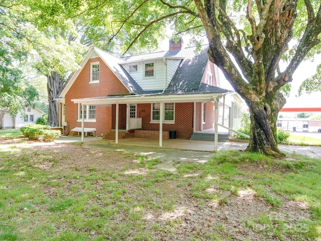 back of property with a patio